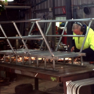 Len Withnall (son of Gordon Withnall) in their workshop working on the Super Sopper.